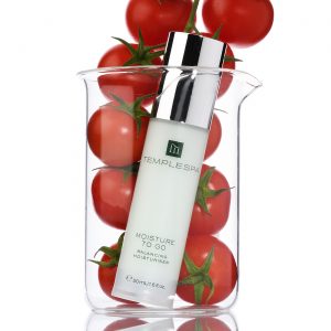 Tomatoes in a beaker with white background